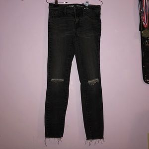 black ripped at the knee mid rise jeggings